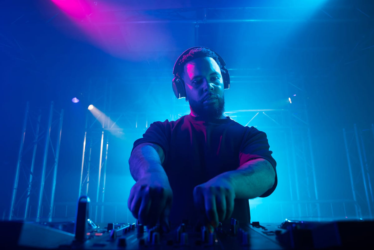 DJ performing with AlphaTheta HDJ-F9 headphones