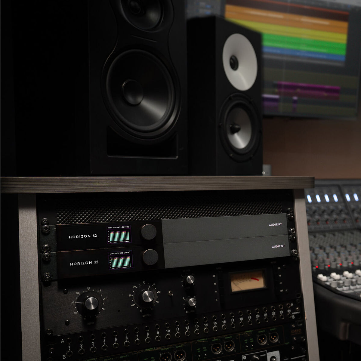 Audient Horizon 32 racked under a studio desk beside a mixing console