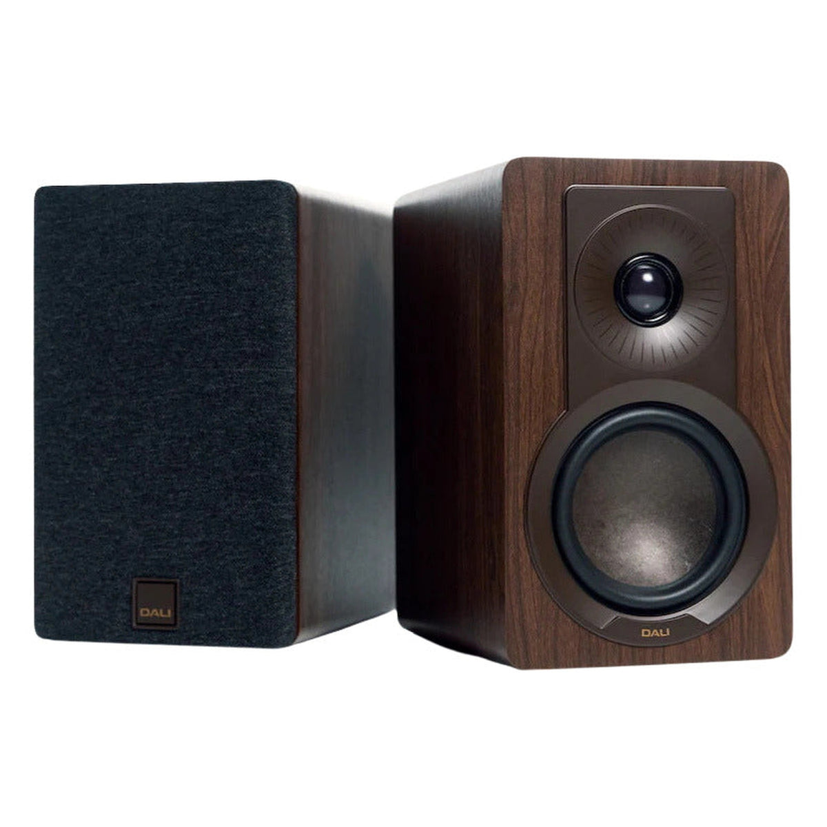 DALI Kupid passive bookshelf speakers shown in a modern living room setting, highlighting their sleek black design and compact size.